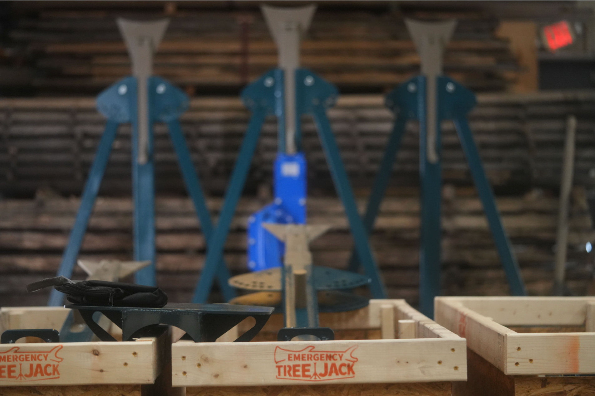 Wooden crates with 'Emergency Tree Jack' branding on a wooden background